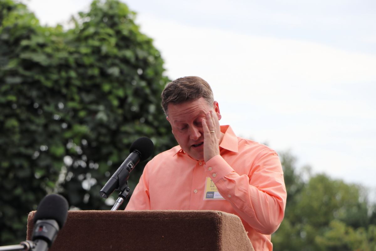 North Woodside civic association president David Cox wipes away a tear at the centennial celebration as he reads a proclamation by his neighborhood renouncing racial restrictive covenants. 